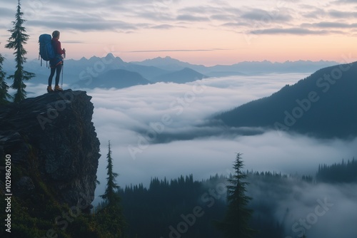 A man with a backpack standing on top of the mountain, overlooking the valley below filled with fog at sunrise, concept of tourism, outdoor activities, hiking