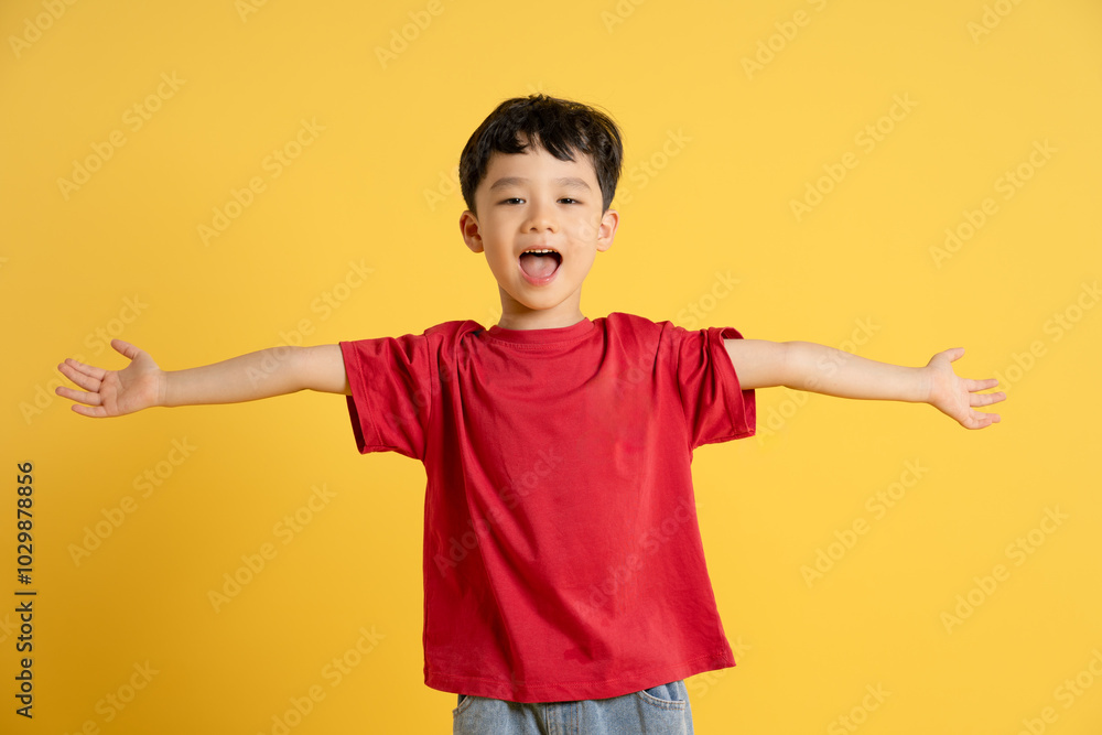 image of asian boy posing on yellow background image of asian boy posing on yellow background