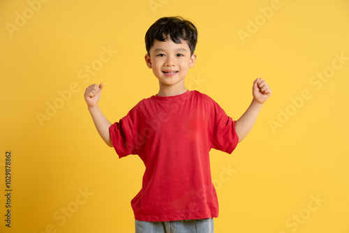 image of asian boy posing on yellow background