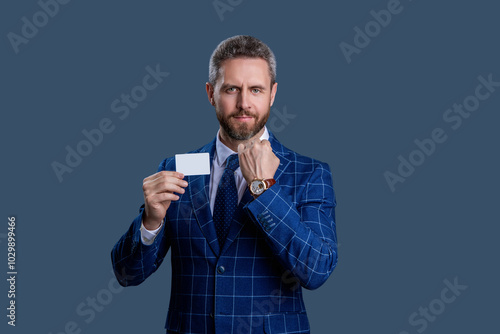 Success of business. Businessman in suit hold credit card isolated on grey. Business branding. Pay the bill. Businessman with credit card. Business deal with emoney. Exchange business cards