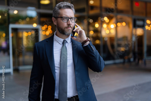 Man in suit talk on phone. Phone call. Mobile communication. Communication. Businessman speak on smartphone outdoor. Mature business man has phone conversation. Business call. Copy space banner