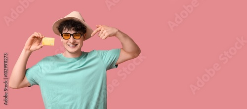 Happy young man holding cre...