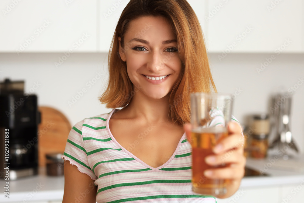 Young woman with glass of juice in kitchen, closeup Young woman with glass of juice in kitchen, closeup