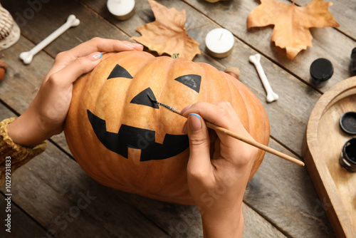 Woman painting Halloween pu...