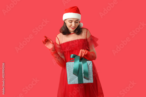 Young woman in Santa hat wi...