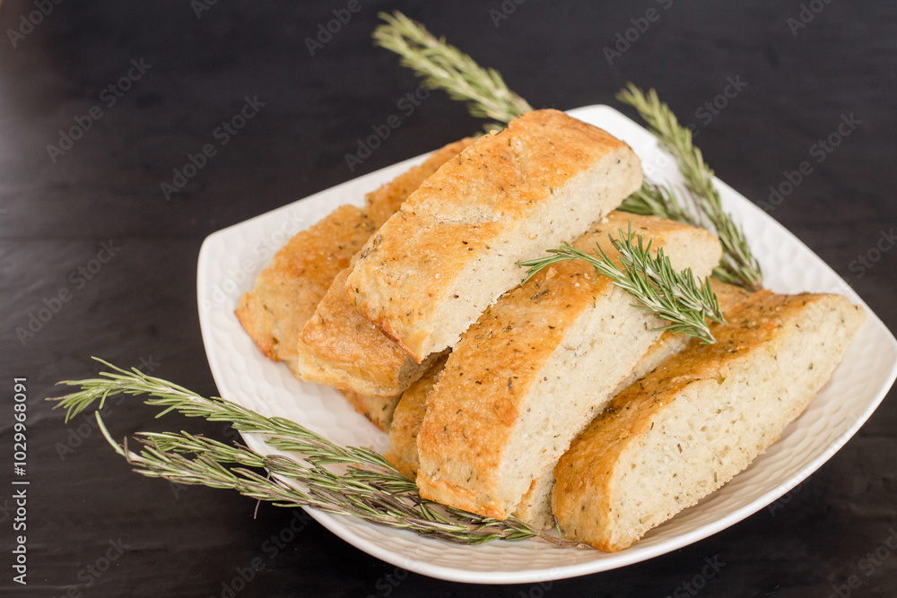 Sliced rosemary bread on a plate Sliced rosemary bread on a plate
