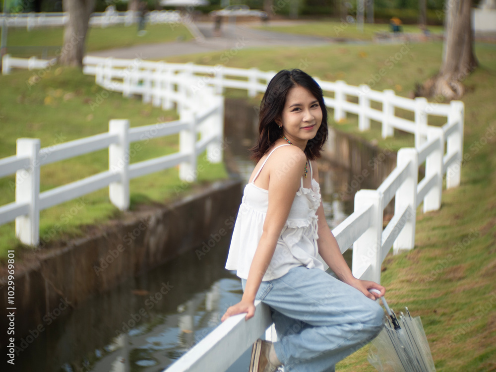 Relax concepts, Beautiful teenage girl on a bright day at a public park in Chiang Mai, Thailand.