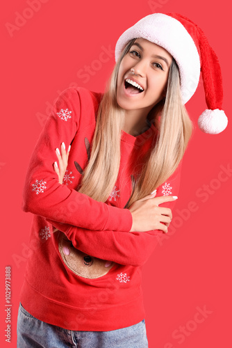 Young woman in Santa hat an...