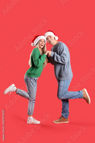 Happy young couple in Santa...