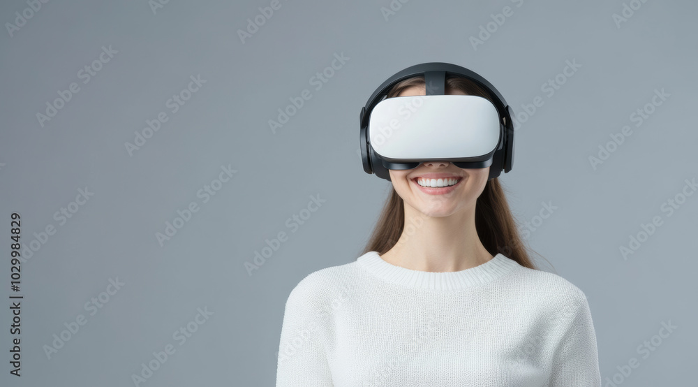 A woman wearing virtual reality headset smiles joyfully, showcasing excitement of immersive technology. Her casual white sweater adds to modern, tech savvy vibe A woman wearing virtual reality headset smiles joyfully, showcasing excitement of immersive technology. Her casual white sweater adds to modern, tech savvy vibe