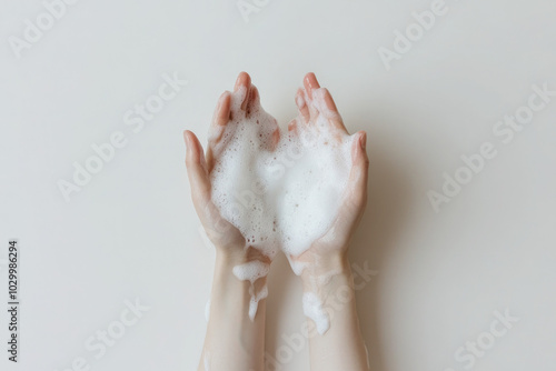 Two hands holding a lot of bubbles, the bubbles are white