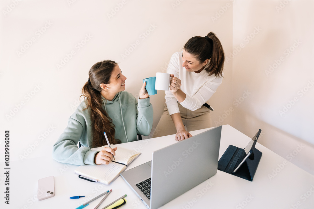 Two university women celebrating the end of the work process. Two university women celebrating the end of the work process.