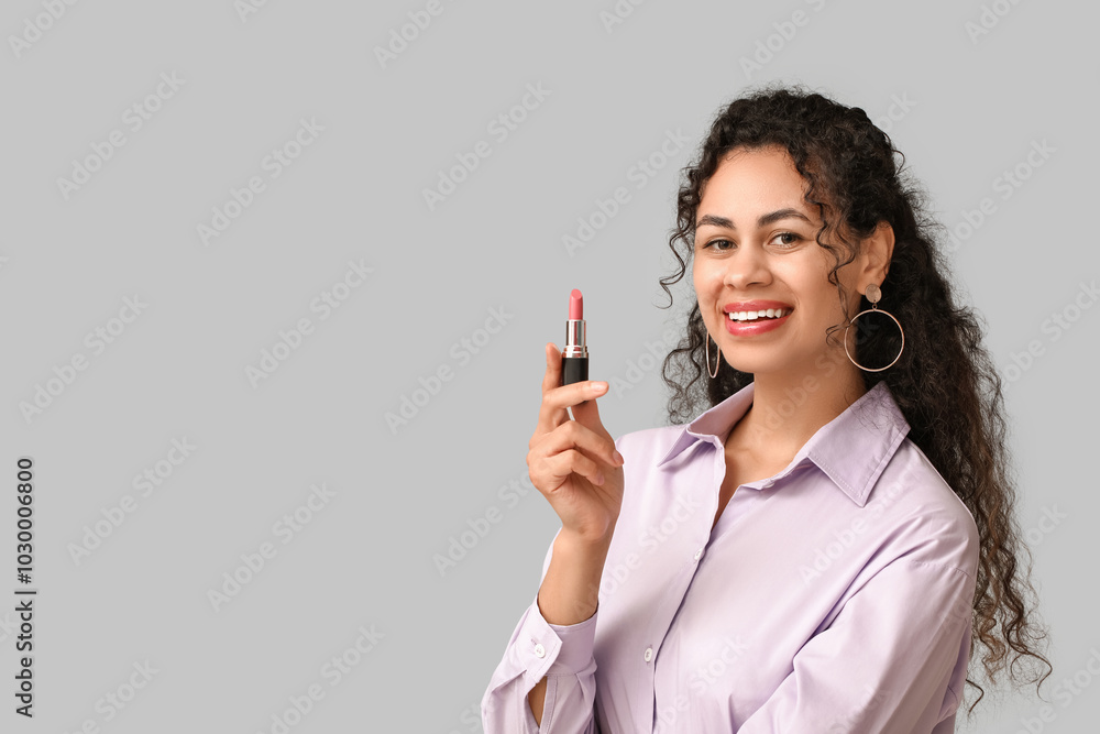 Happy young African-American woman with pink lipstick on grey background Happy young African-American woman with pink lipstick on grey background