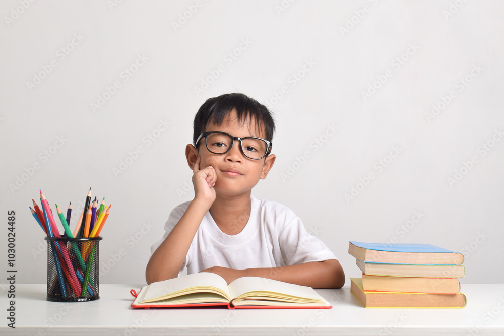 Portrait of a smart Asian boy studying isolated on a white background Portrait of a smart Asian boy studying isolated on a white background