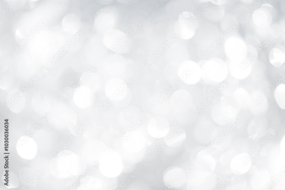 Abstract blurred glowing silver bokeh background, festive season concept background Abstract blurred glowing silver bokeh background, festive season concept background