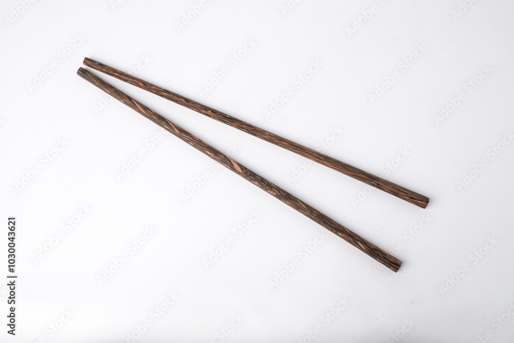 Close-up photo of oriental wooden chopsticks isolated on white background. High angle, Flat Lay Setup.