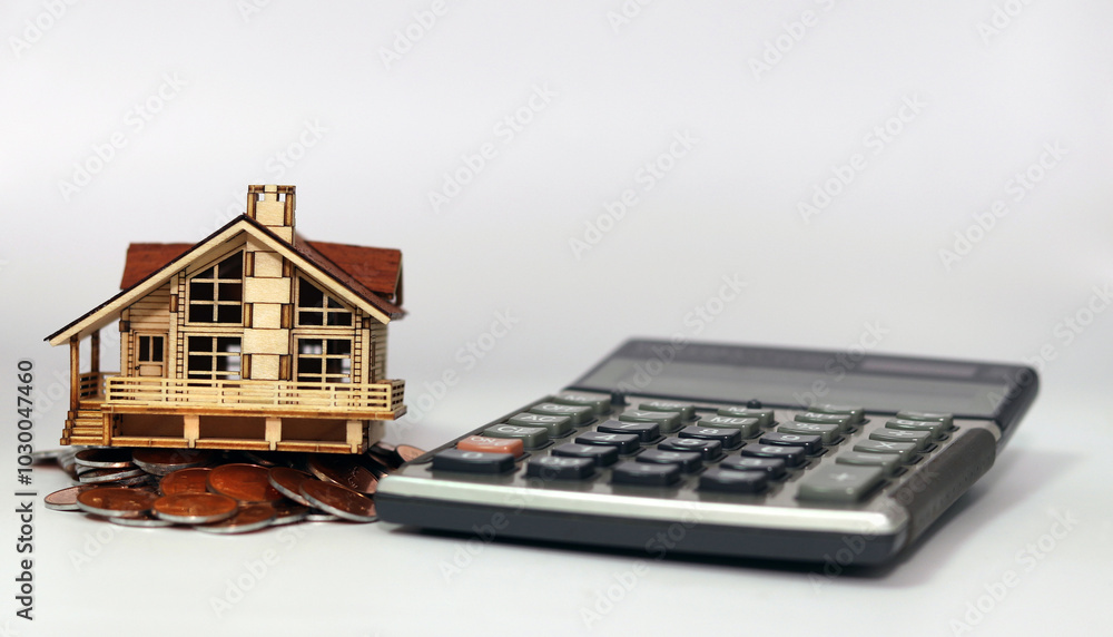 On a white background lies a calculator and a slanted house on top of a pile of coins. instability in the real estate market.
On a white background lies a calculator and a slanted house on top of a pile of coins. instability in the real estate market.