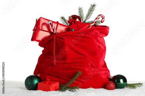 Santa bag with gift boxes, Christmas balls, candy canes and fir branches on white background photo