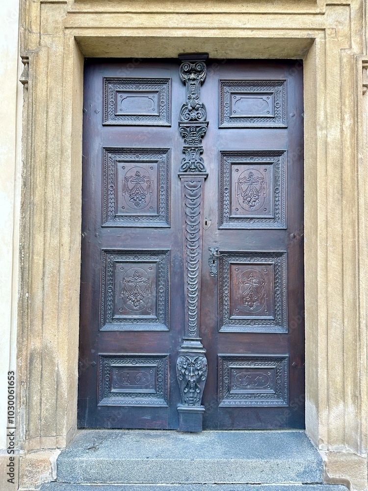 The photograph captures a close-up of an old medieval gate, crafted from wood and metal, set in the charming streets of a historic European city. The photograph captures a close-up of an old medieval gate, crafted from wood and metal, set in the charming streets of a historic European city.