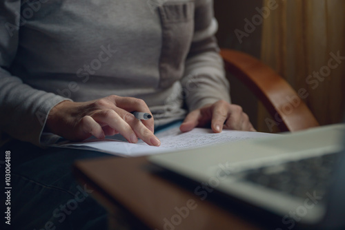 Canvas-taulu Female freelancer doing paperwork in home office interior