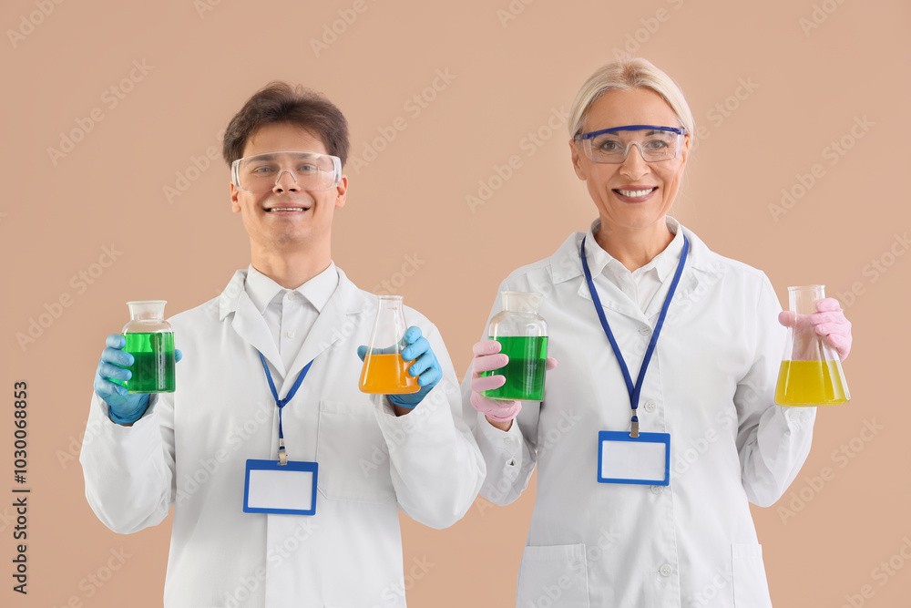 Chemists with flasks on beige background Chemists with flasks on beige background