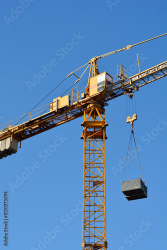 Detail of a construction tower crane against blue sky