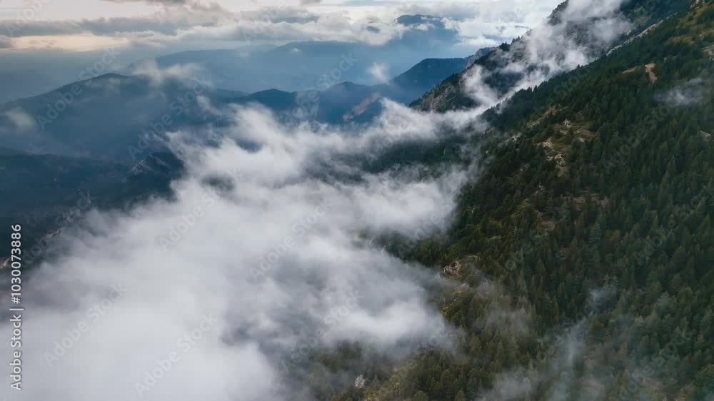 Dramatic mountain landscape with low-hanging clouds in the early morning hours Dramatic mountain landscape with low-hanging clouds in the early morning hours