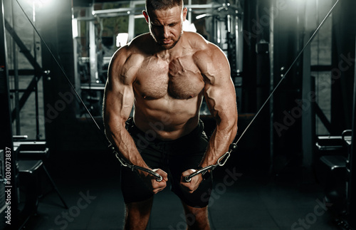 Obraz na płótnie Muscular man having training with weights. Brutal strong athletic men pumping up muscles workout. Concept bodybuilder doing exercises in gym. w salonie