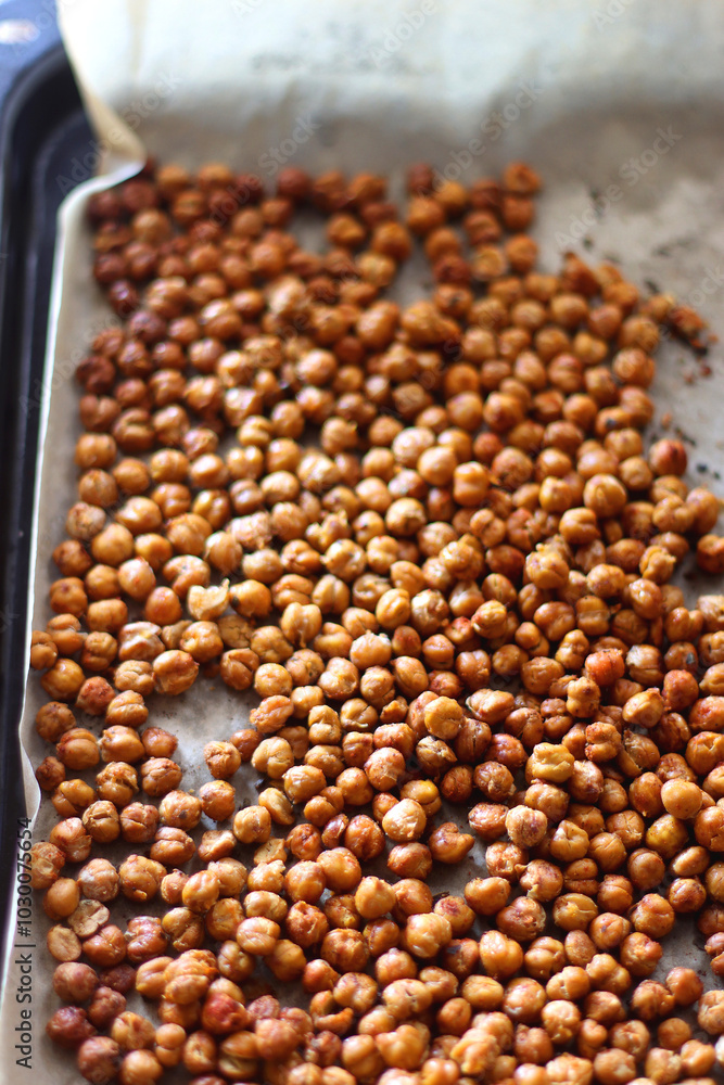 Sheet pan with homemade roasted chickpeas. Selective focus. Sheet pan with homemade roasted chickpeas. Selective focus.