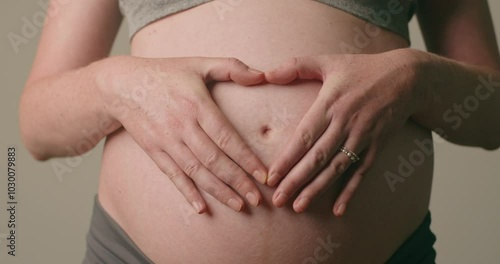Wallpaper Mural Pregnant Woman Making Heart Shape on Her Belly: A Symbol of Love, Motherhood, and Family Torontodigital.ca