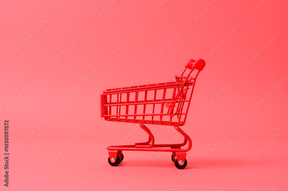 Small shopping cart on a pink background. Black Friday, sale Small shopping cart on a pink background. Black Friday, sale