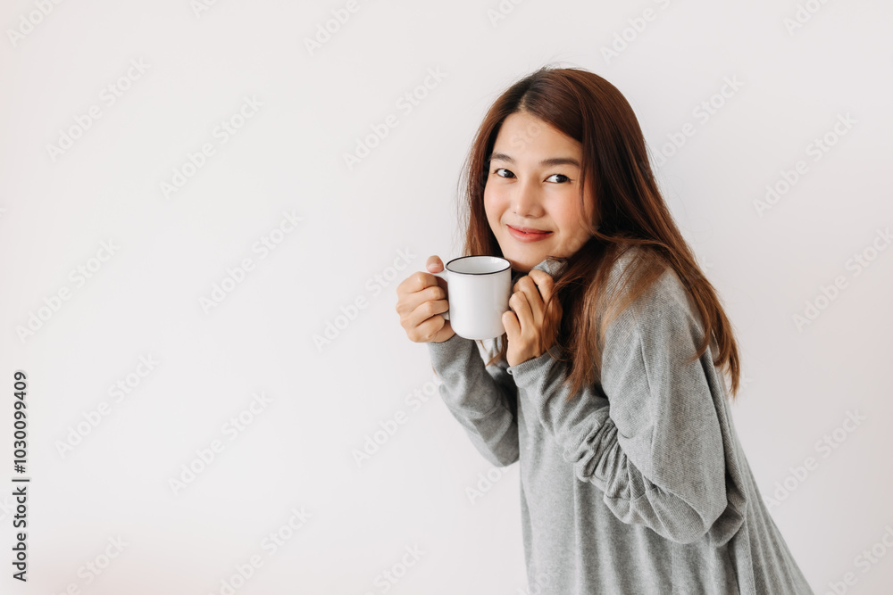 Happy asian woman holding and showing white cup with smiling face in winter, drinking hot water coffee, making warm, isolated over white background wall. Happy asian woman holding and showing white cup with smiling face in winter, drinking hot water coffee, making warm, isolated over white background wall.