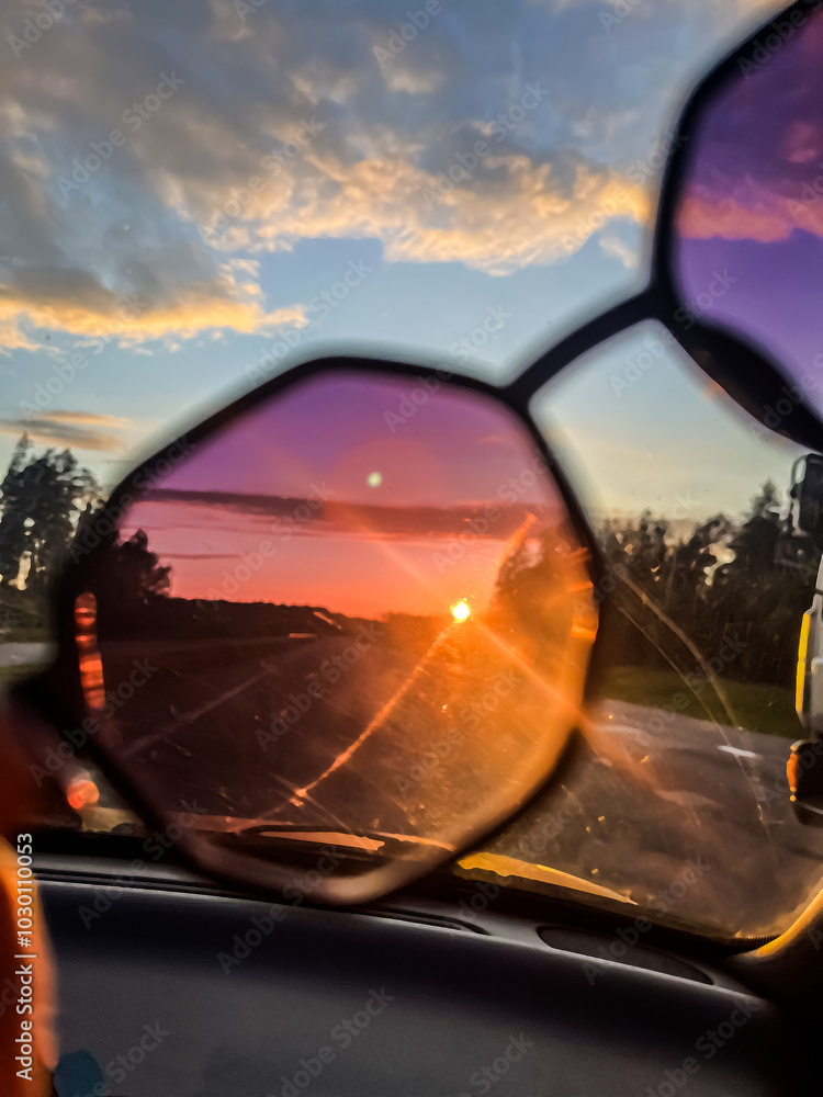 sunglasses in hands and through them the sunset is visible sunglasses in hands and through them the sunset is visible