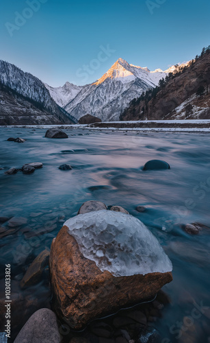 Wide River Flowing Through Pangi Valley at Dusk, with Hilu Tuwan Peak in Summer photo