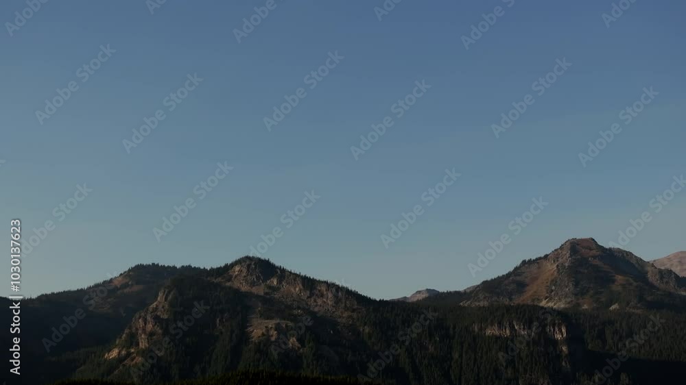 Panoramic Aerial View of Mount Rainier's Rugged Peaks, Glacial Slopes and Surrounding Landscape Under Clear Blue Sky Panoramic Aerial View of Mount Rainier's Rugged Peaks, Glacial Slopes and Surrounding Landscape Under Clear Blue Sky