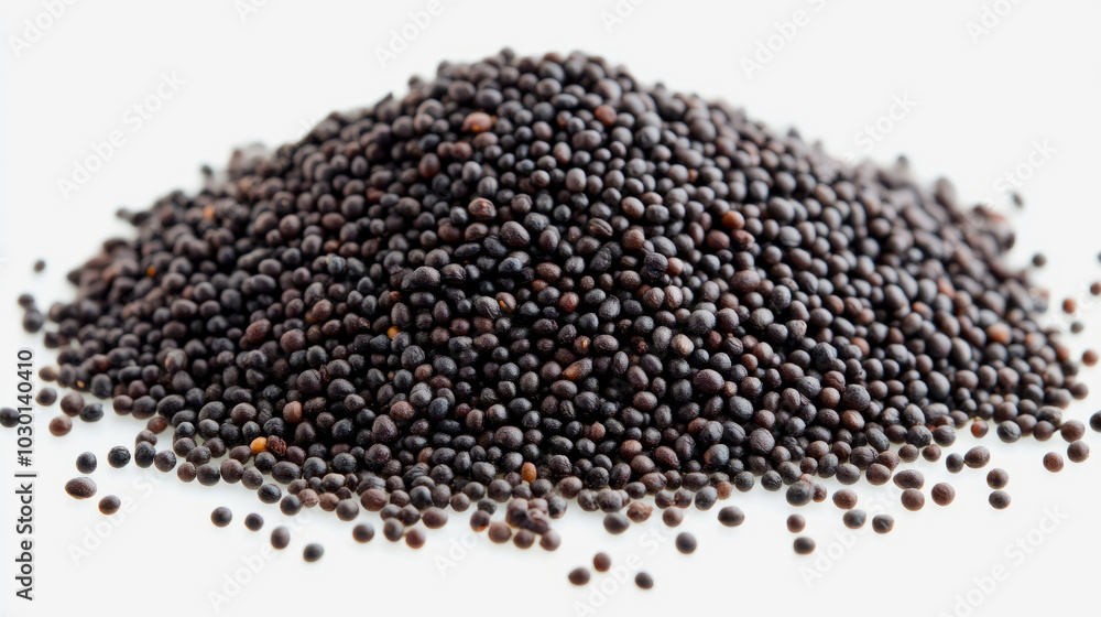 A heap of whole black mustard seeds with their tiny, round shape, scattered on a white background A heap of whole black mustard seeds with their tiny, round shape, scattered on a white background