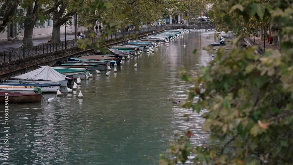 Tranquil waterway with boats moored along a peaceful canal, perfect for quiet reflection Tranquil waterway with boats moored along a peaceful canal, perfect for quiet reflection