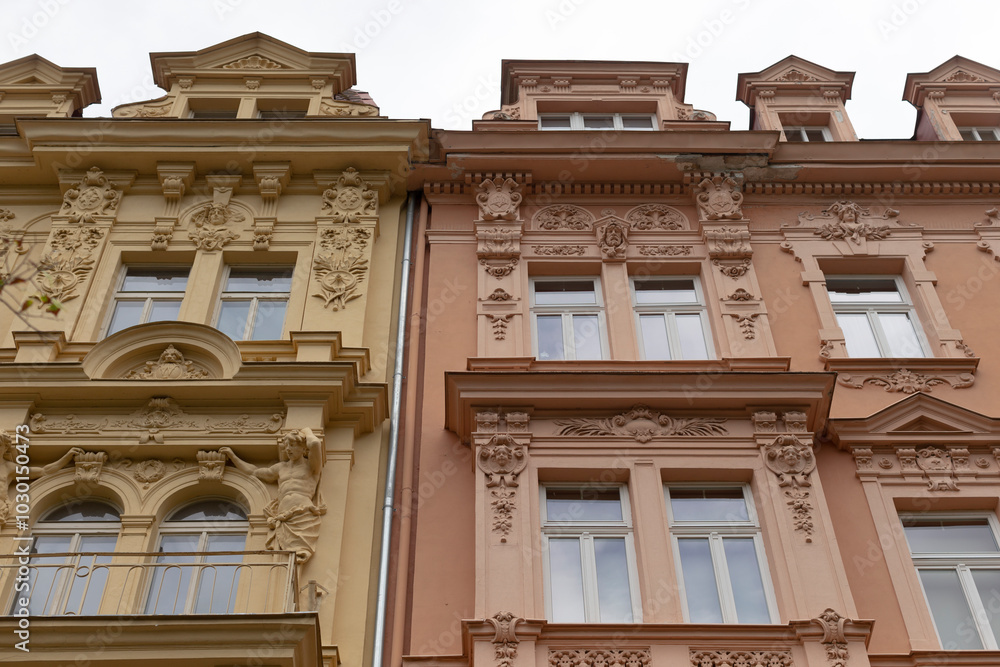 A beautifully designed building that features a balcony elegantly situated on the side, adding charm and character to its overall appearance A beautifully designed building that features a balcony elegantly situated on the side, adding charm and character to its overall appearance