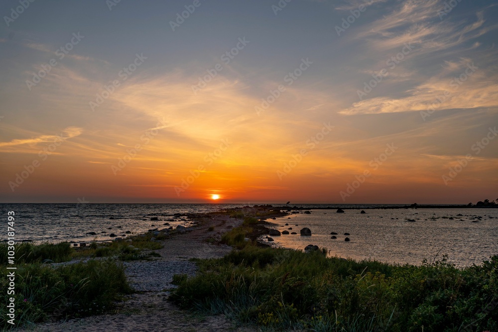 Serene sunset over rocky coastline Serene sunset over rocky coastline