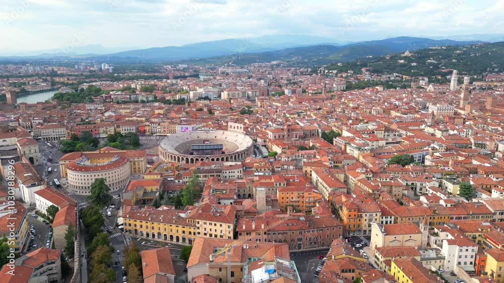 the city of Verona with its arena and mountain in the background, on a sunny day in Veneto, Italy the city of Verona with its arena and mountain in the background, on a sunny day in Veneto, Italy