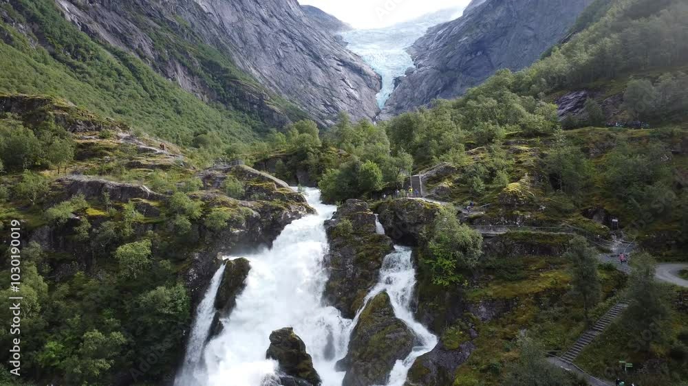 Drone view of Kleiva Fossen waterfall on green-covered mountain at the daytime in Briksdal, Norway Drone view of Kleiva Fossen waterfall on green-covered mountain at the daytime in Briksdal, Norway