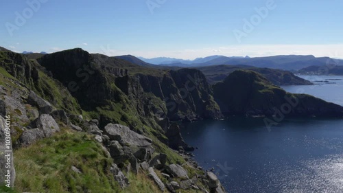 Wallpaper Mural Scenic view of rocky cliffs overlooking sea on a sunny day with blue sky on Runde Island in Norway Torontodigital.ca