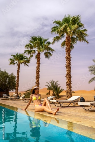 Woman relaxing by a pool in a desert resort.