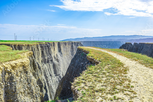 Gravel road and Anjihai Grand Canyon weathered mountain natural landscape in Xinjiang. Famous travel destination. photo