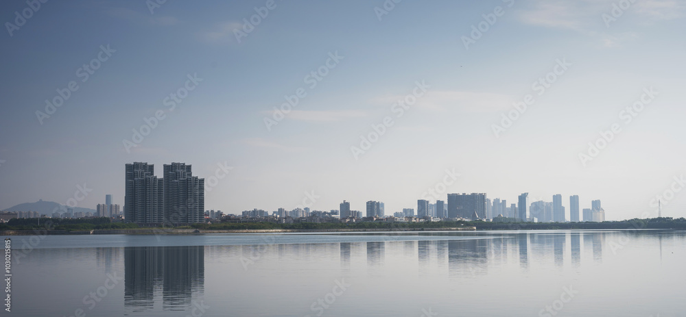 Modern city skyline reflected in calm water
Modern city skyline reflected in calm water