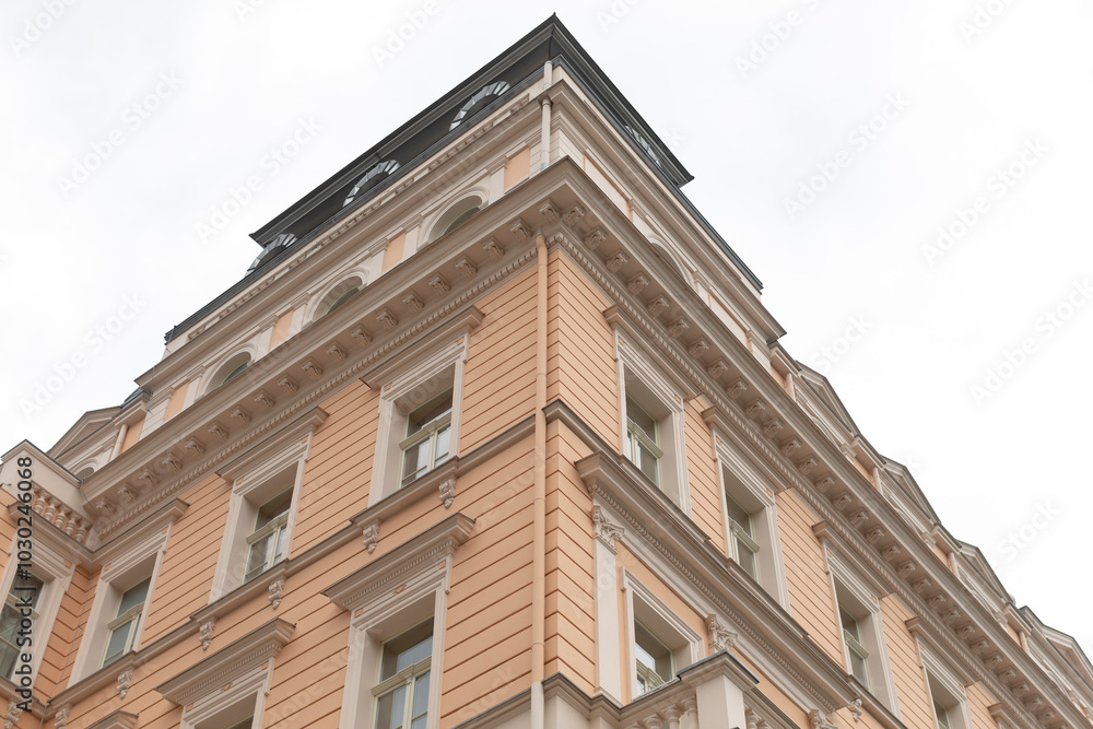 A large and impressive building with a large clock prominently displayed on the top of it, making it a notable landmark in the skyline A large and impressive building with a large clock prominently displayed on the top of it, making it a notable landmark in the skyline