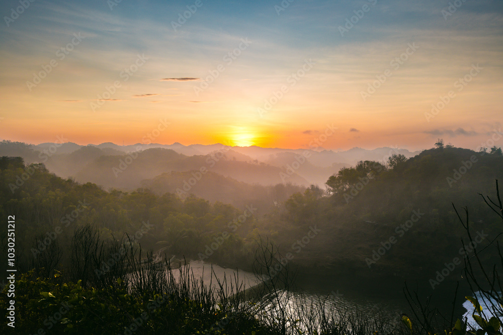 Breathtaking panoramic view of a valley bathed in the warm glow of the rising sun Breathtaking panoramic view of a valley bathed in the warm glow of the rising sun