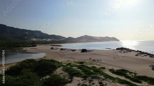Wallpaper Mural Aerial drone footage over a white sand beach camp on the ocean with a large dune in the background, Oaxaca, Mexico Torontodigital.ca