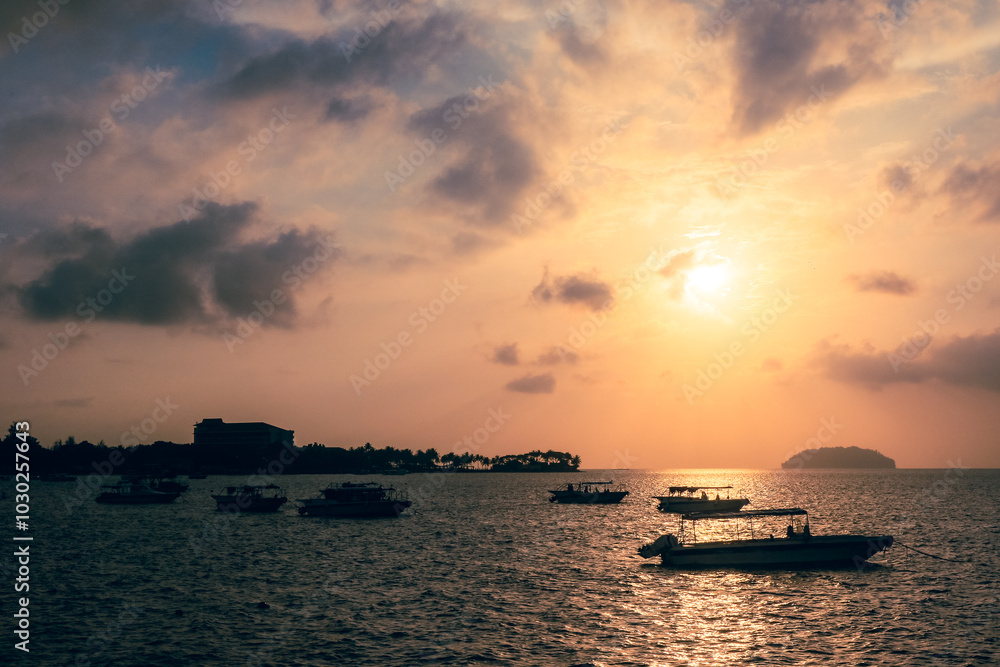 Sunset over Kota Kinabalu with boats on the water as the day transitions into evening Sunset over Kota Kinabalu with boats on the water as the day transitions into evening