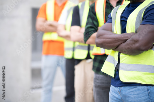 Close up Young black engineer cross arm at chest at work site. Portrait of engineer holding white hard hat at factory looking at camera with smile. and space.